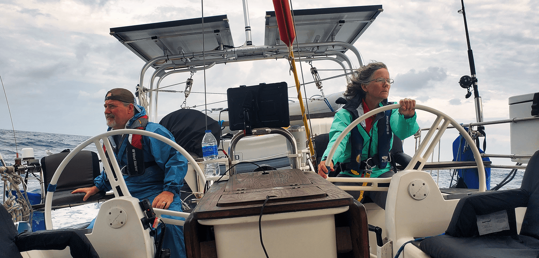 Couple sailing together on coastal waters