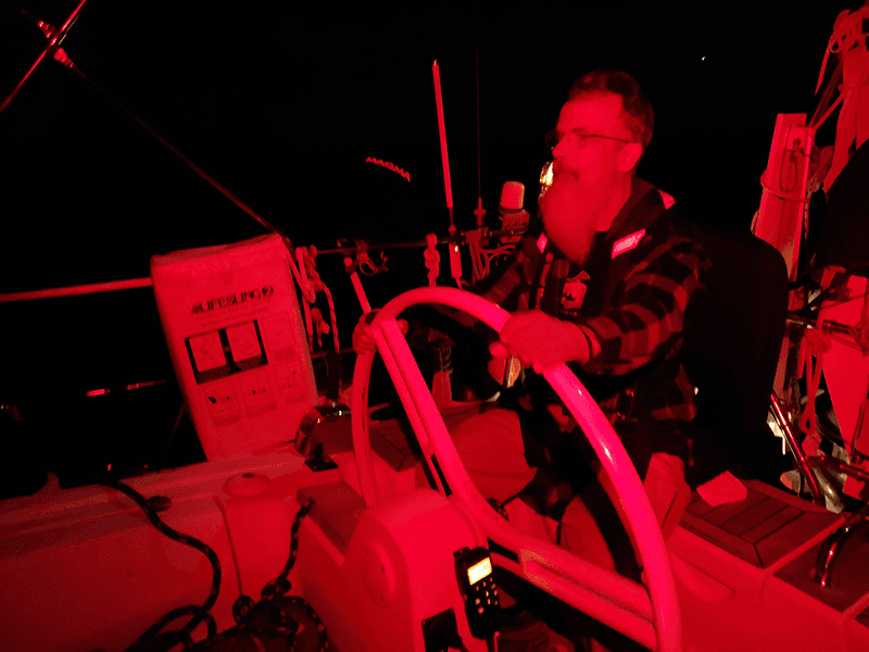 Sailors on night passage during offshore sailing