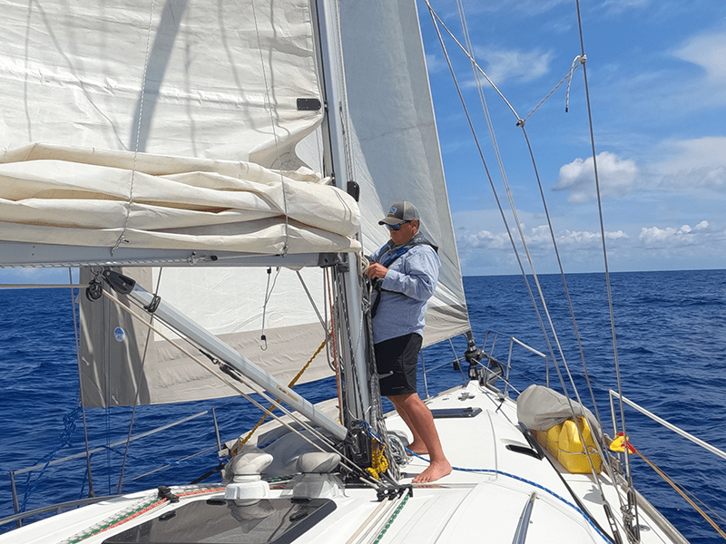 Sailors reefing sails during offshore training
